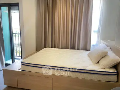 Modern bedroom with cozy bed and balcony access, perfect for relaxation and comfort.