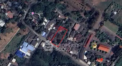 Aerial view of residential area with highlighted property boundary in vibrant neighborhood.