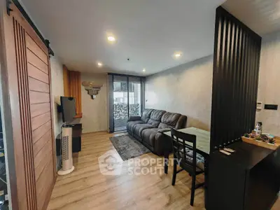 Modern living room with cozy sofa and dining area, featuring stylish wooden accents and ample natural light.