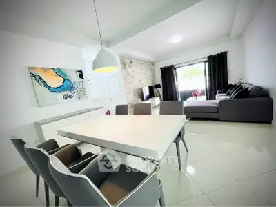 Modern living room with sleek dining area and stylish decor