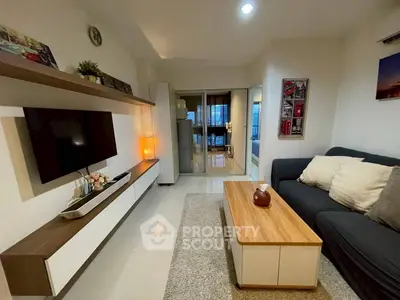 Modern living room with sleek furniture and stylish decor, featuring a cozy sofa and wall-mounted TV.