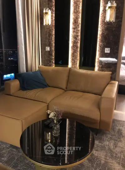 Luxurious living room with plush leather sofa and elegant lighting, perfect for modern urban living.