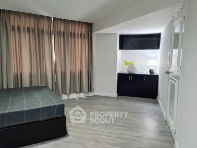 Spacious bedroom with modern decor and natural light