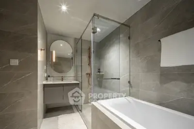 Luxurious modern bathroom with elegant gray tiles and glass shower enclosure