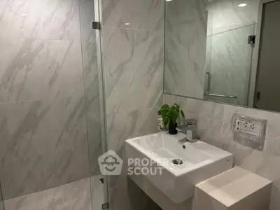 Modern bathroom with sleek sink and glass shower enclosure