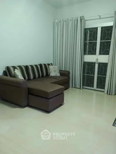 Cozy living room with modern sofa and elegant curtains