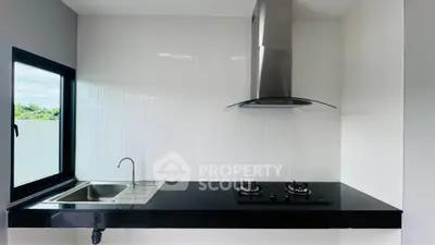Modern kitchen with sleek black countertop and gas stove