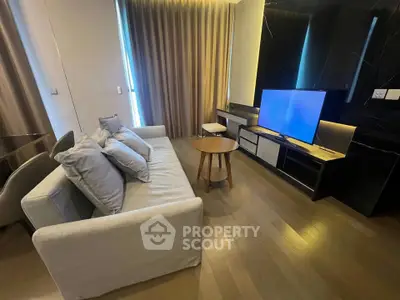 Modern living room with sleek furniture and large TV, perfect for relaxation and entertainment.