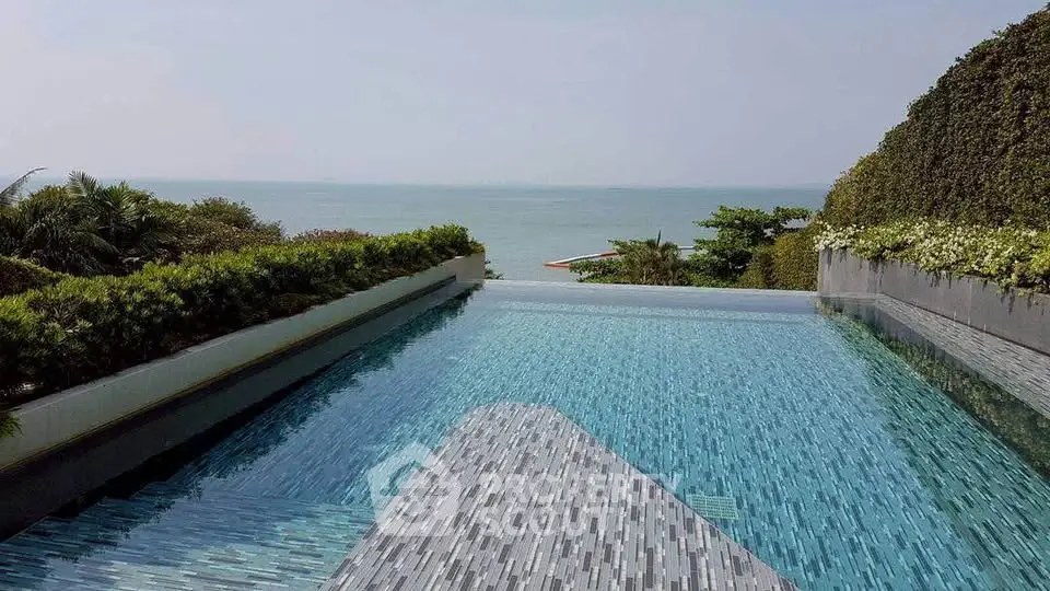 Luxurious infinity pool with stunning ocean view and lush greenery, perfect for relaxation and leisure.