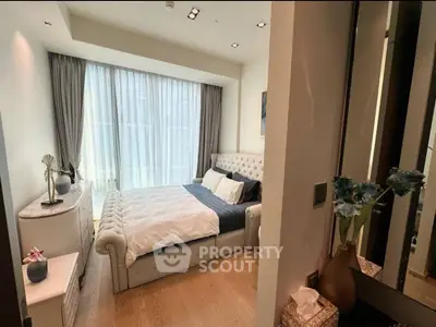 Luxurious bedroom with elegant decor and large window for natural light.