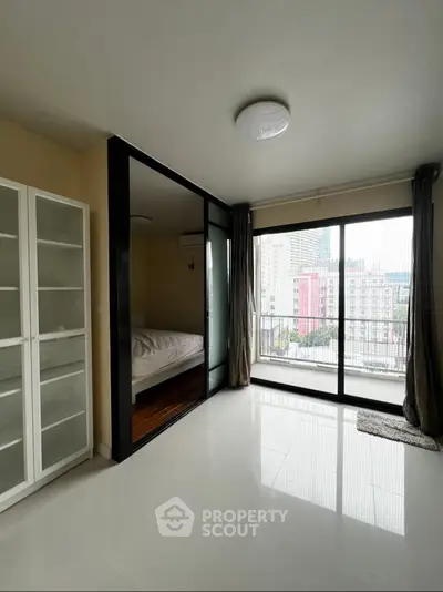 Modern apartment with glass partitioned bedroom and city view balcony
