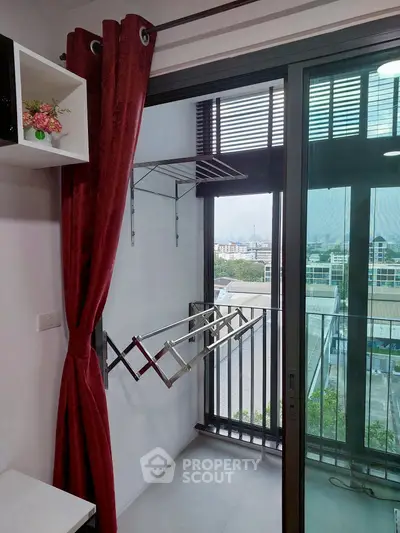 Modern condo balcony with sliding glass doors and city view