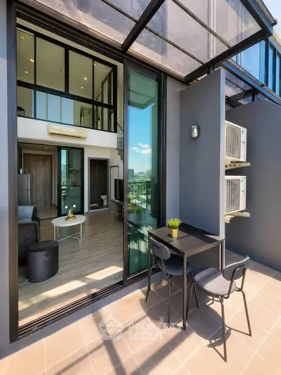 Modern apartment with balcony and stylish interior design, featuring floor-to-ceiling windows and city view.