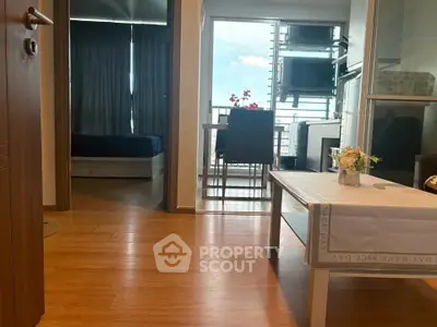 Modern apartment interior with wooden flooring and balcony view