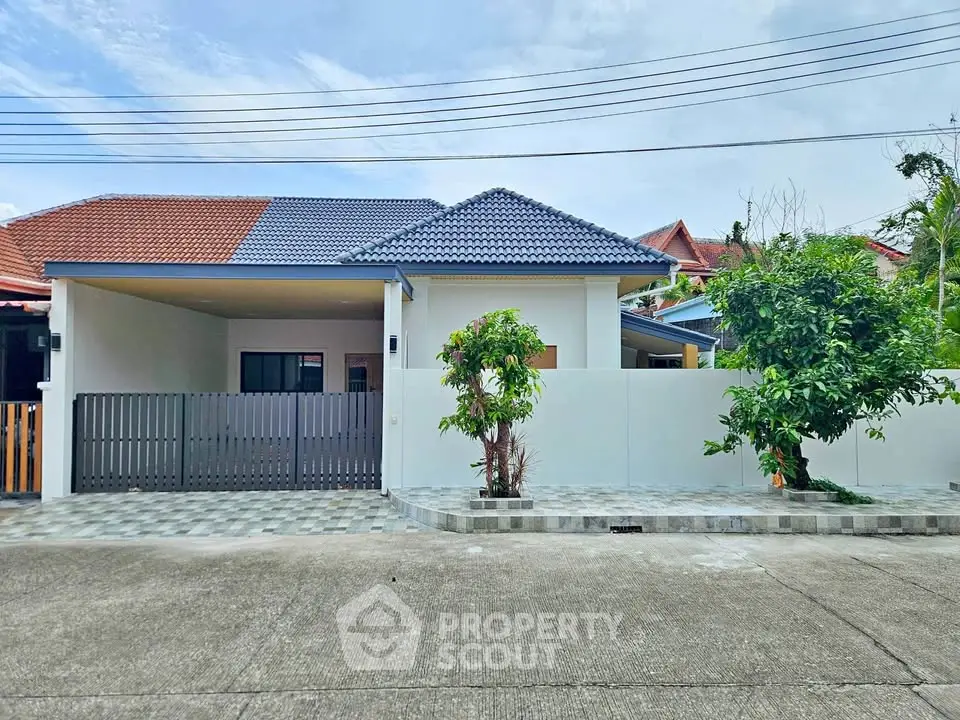 Charming single-story home with modern roof and spacious driveway in a serene neighborhood.