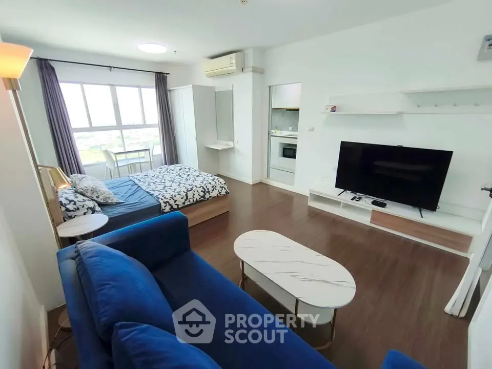Modern studio apartment with stylish furniture and large window view