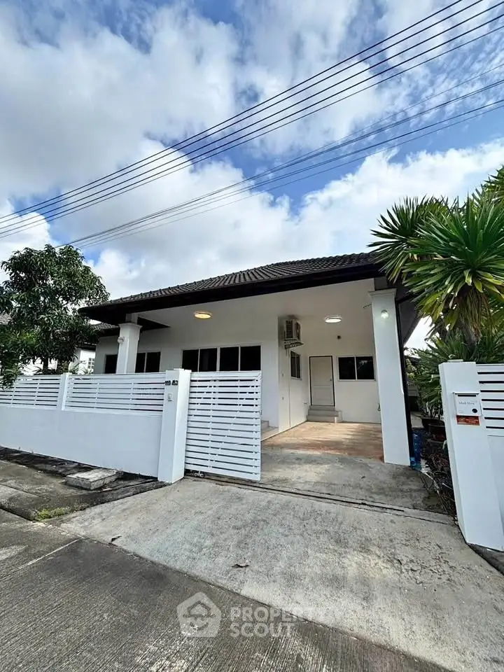 Charming single-story house with modern design and spacious driveway in a serene neighborhood.