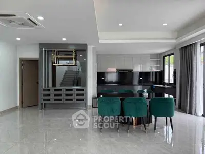 Modern open-plan living area with sleek kitchen and elegant dining space.