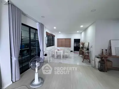 Spacious modern living room with elegant decor and large windows for natural light.