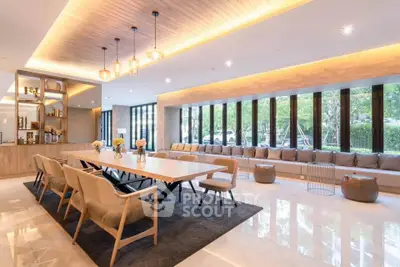 Luxurious modern living room with elegant dining area and large windows offering natural light.