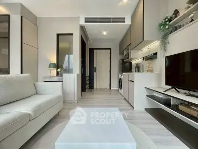 Modern living room with sleek kitchen and cozy seating area