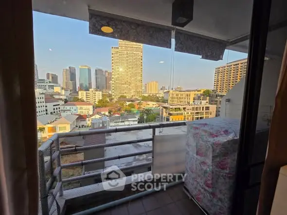 Stunning cityscape view from a cozy balcony in a high-rise apartment.