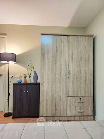 Modern bedroom with stylish wardrobe and cozy lighting, perfect for urban living.