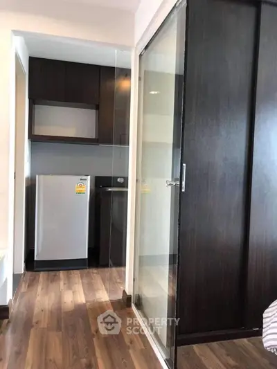 Modern apartment interior with sleek kitchen and wooden flooring