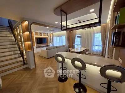 Luxurious open-plan living room with modern kitchen and stylish bar seating