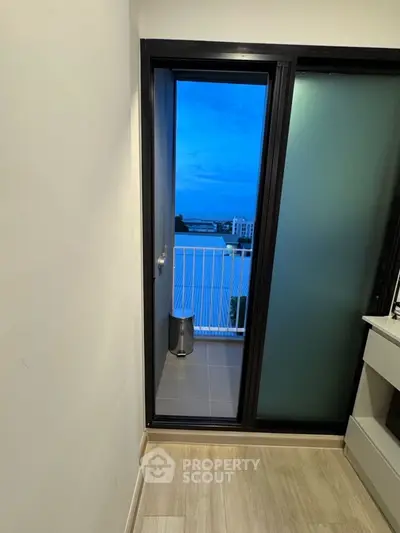 Modern balcony view with sliding glass door and cityscape