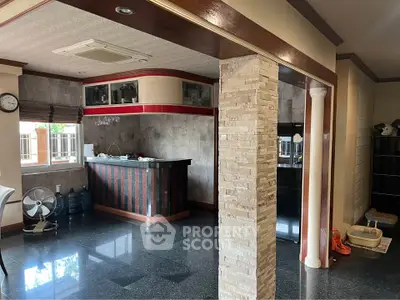 Spacious open-plan living area with stylish bar and modern finishes