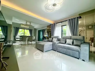 Spacious modern living room with elegant decor and large windows for natural light.