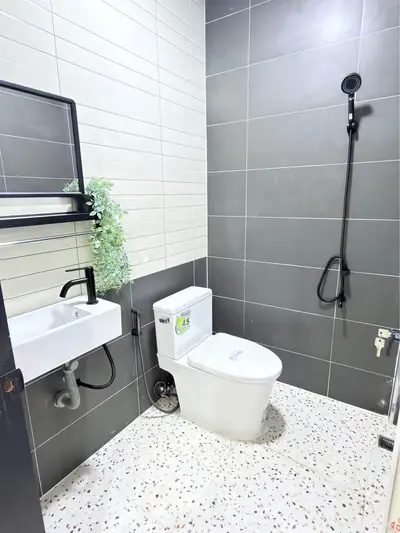 Modern bathroom with sleek tiles and contemporary fixtures, perfect for a stylish home.