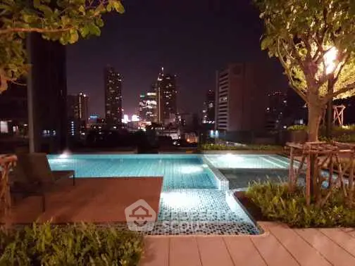 Luxurious rooftop pool with stunning city skyline view at night