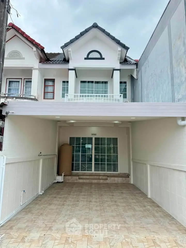 Charming townhouse with covered parking and elegant facade in a serene neighborhood.