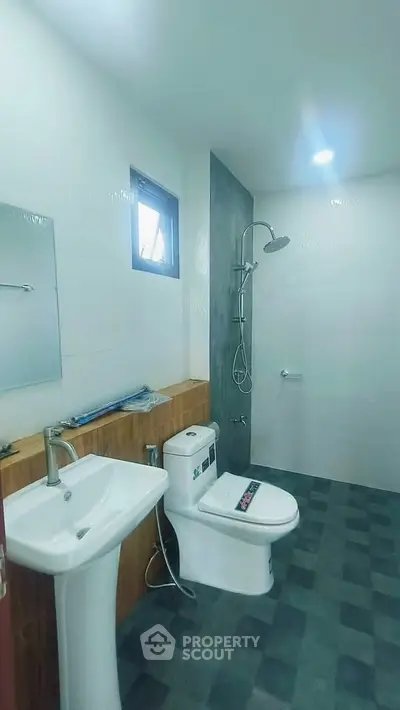 Modern bathroom with sleek fixtures and spacious shower area