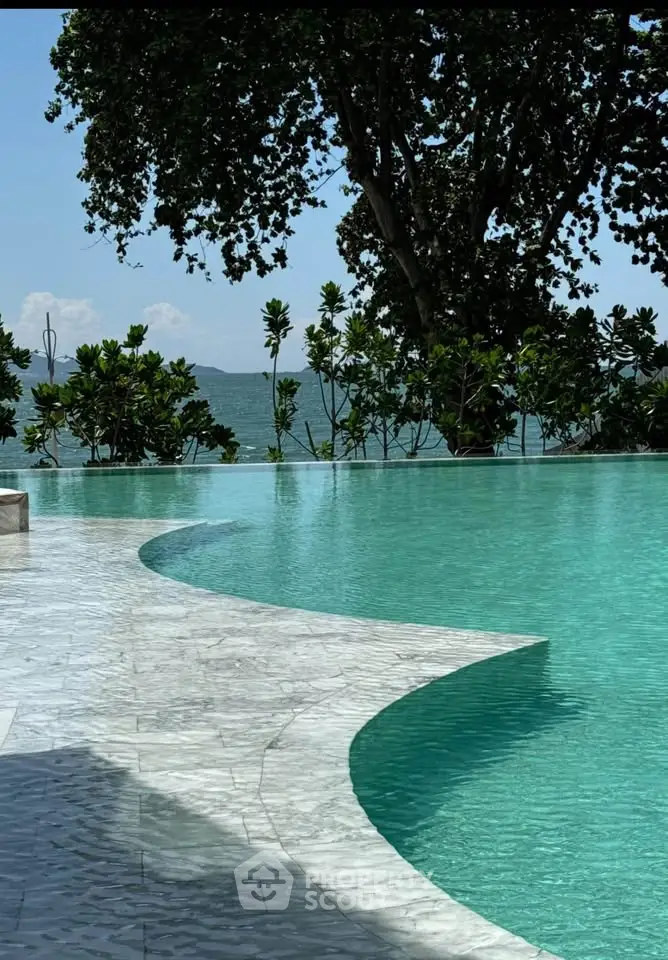 Luxurious infinity pool with stunning ocean view and lush greenery