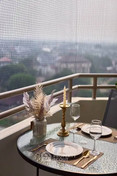 Charming balcony with elegant dining setup and scenic view, perfect for outdoor relaxation and entertaining.