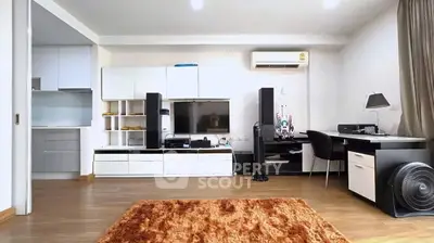Modern living room with sleek furniture and home office setup