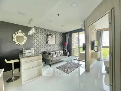 Modern living room with stylish decor and open layout, featuring a cozy sofa and large windows.