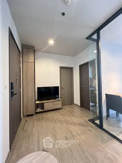 Modern apartment interior with wooden flooring and glass partition