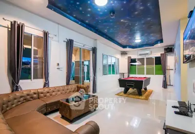 Luxurious living room with pool table and starry ceiling, perfect for entertainment and relaxation.