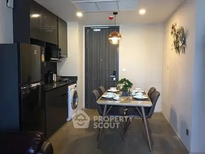 Modern kitchen with dining area featuring sleek appliances and stylish decor