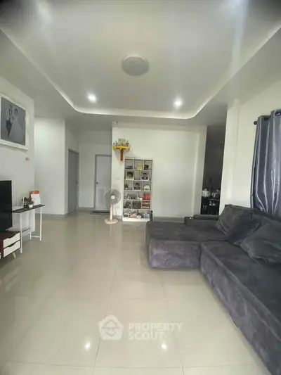 Spacious living room with modern decor and comfortable seating in a stylish home.