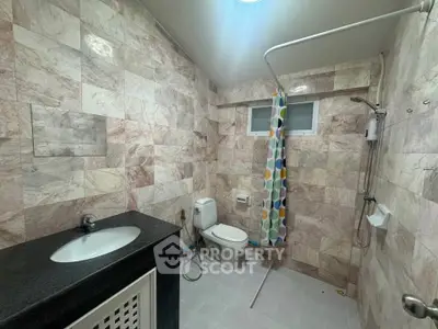 Spacious bathroom with modern fixtures and stylish tile design, perfect for a contemporary home.
