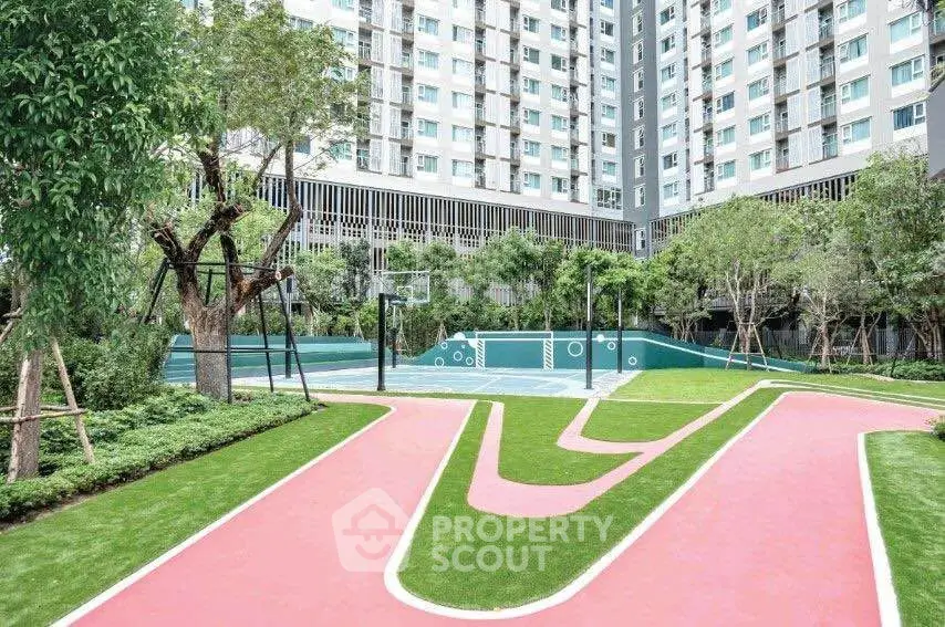 Modern residential complex with landscaped garden and sports court, ideal for active urban living.