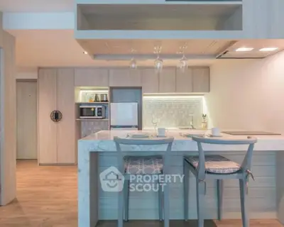 Modern kitchen with marble island and stylish bar stools in open layout