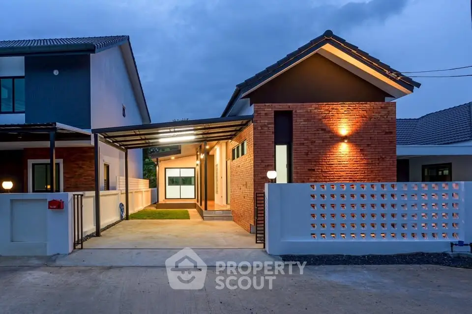 Modern single-story home with brick facade and covered carport at dusk.