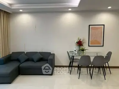 Modern living room with sleek gray sofa and stylish dining area