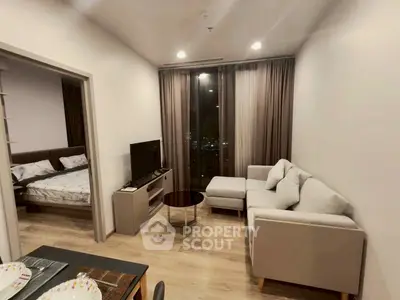 Modern living room with cozy sofa and TV, adjacent to a stylish bedroom, perfect for urban living.
